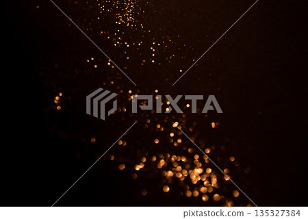 Golden abstract bokeh on black background. Golden abstract bokeh on black background. 135327384