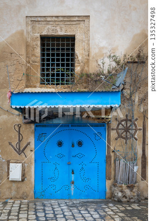 Traditional blue gate in Bizerte medina, Tunisia 135327498
