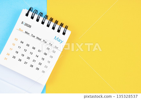 May 2026, Monthly desk calendar for 2026 year on yellow and blue background. 135328537