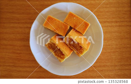 Pineapple cake on a white plate Pineapple cake on a white plate 135328568