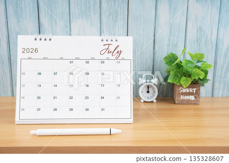 July Monthly desk calendar for 2026 year and alarm clock. July Monthly desk calendar for 2026 year and alarm clock. 135328607