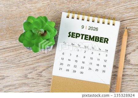 September 2026 monthly desk calendar and pencil with plant pot decoration. 135328924