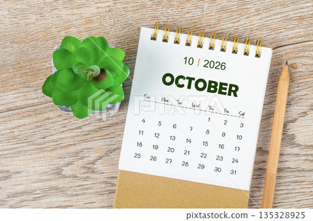 October 2026 monthly desk calendar and pencil with plant pot decoration. October 2026 monthly desk calendar and pencil with plant pot decoration. 135328925