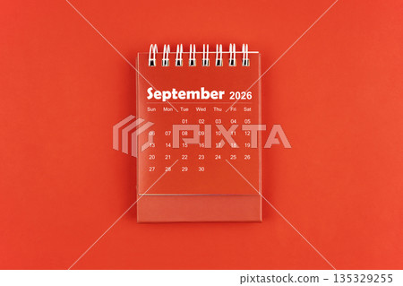 September 2026 red color desk calendar on red  background. 135329255