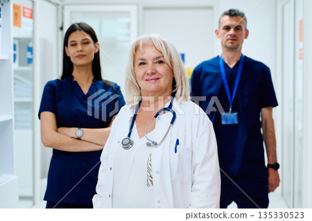 Healthcare professionals in a modern clinic standing together confidently during a busy workday Healthcare professionals in a modern clinic standing together confidently during a busy workday 135330523