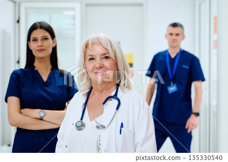 Group of healthcare professionals in a hospital corridor during a busy shift 135330540