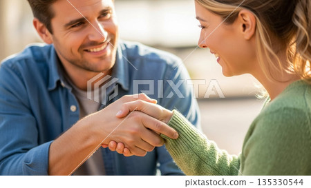 Two People Shaking Hands with Genuine Gratitude After One Helped Find the Others Lost Item, Expressing Sincere Appreciation 135330544