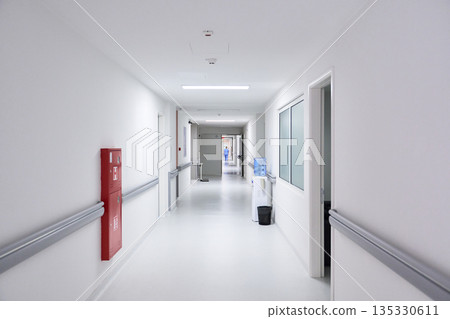 Long and bright hospital corridor showing clarity and cleanliness in a modern healthcare facility Long and bright hospital corridor showing clarity and cleanliness in a modern healthcare facility 135330611