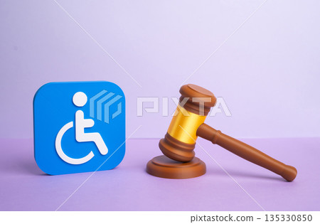 Symbol of a person with a disability and a judge's gavel. Court decision on granting or revoking disability status. Benefits and rights under new laws, legal review and social protection mechanisms 135330850