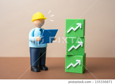 A construction worker in a hard hat and blocks with growth symbols. Improved efficiency and productivity indicators. Income growth. Workforce performance gains, output metrics 135330871