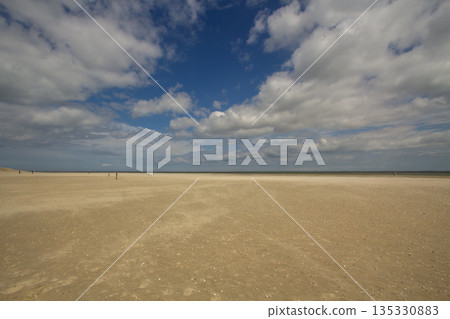 A gust of wind blowing over the beach A gust of wind blowing over the beach 135330883