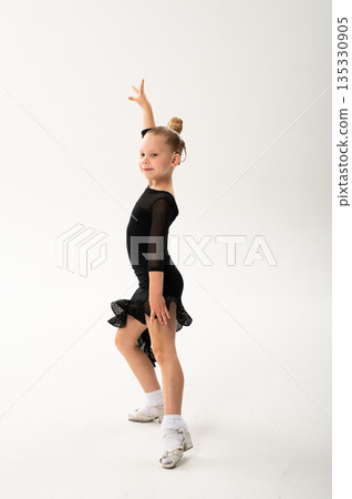 Ballroom dancer with cochlear implant standing in black costume in studio. Pediatric hearing rehabilitation, posture training and inclusive artistic development through body control Ballroom dancer with cochlear implant standing in black costume in studio. Pediatric hearing rehabilitation, posture training and inclusive artistic development through body control 135330905