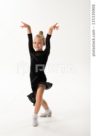 Ballroom dancer with cochlear implant wearing black costume posing in studio. Pediatric hearing support, artistic rehabilitation and inclusive dance training through controlled movement 135330908