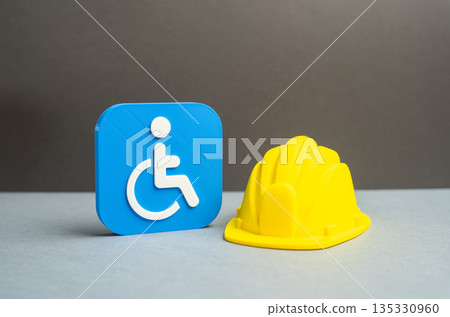 Disability symbol and yellow construction hard hat. Workplaces for people with disabilities. Accessible workplaces. Barrier-free environment and infrastructure promoting equal employment 135330960