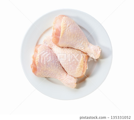 raw chicken legs or chicken drumsticks on a plate isolated on a white background, top view. raw chicken legs or chicken drumsticks on a plate isolated on a white background, top view. 135331052
