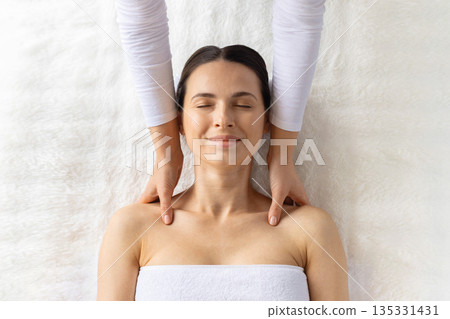 Young beautiful woman relaxing during professional spa shoulder massage, top view 135331431