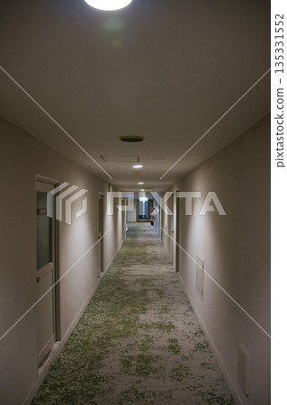 An empty hallway leading to the back of a building 135331552