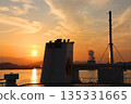 The sunset on the boat: a crossroads between nature and industry 135331665