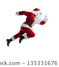 Santa runs energetically during the holiday season in a simple studio setting with gray backdrops 135331676