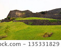 History told through stone walls and the remains of a hill surrounded by greenery 135331829