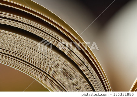 Artistic macro view of the rhythmic curves and textures of book pages Artistic macro view of the rhythmic curves and textures of book pages 135331996