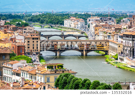 Aerial view of Ponte Vecchio in Florence (Ponte Vecchio, Firenze) and surrounding buildings along the Arno River, showcasing the historic bridge and riverside from above. 135332016