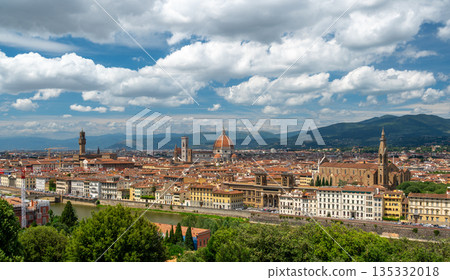 Panoramic view of Florence (Firenze), Italy, showing rooftops, landmarks like Palazzo Vecchio and Santa Maria del Fiore with its red dome, and hills with forests on a sunny summer day. Panoramic view of Florence (Firenze), Italy, showing rooftops, landmarks like Palazzo Vecchio and Santa Maria del Fiore with its red dome, and hills with forests on a sunny summer day. 135332018