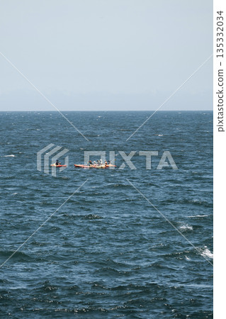 Summer adventure, group of people kayaking in open sea on a sunny day 135332034