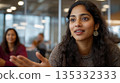 Young South Asian woman contributing ideas in a board meeting with a focus on fresh perspectives and inclusion 135332333
