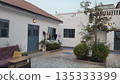 Gambian Quiet Courtyard with White Houses, Blue Doors and Hanging Laundry 135333399