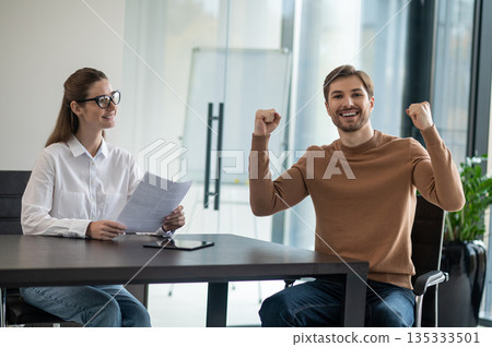 Young man feeling excited after a positive interview with HR manager Young man feeling excited after a positive interview with HR manager 135333501