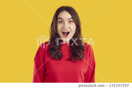 Amazed brunette woman with opened mouth emotional face expression on yellow background. Amazed brunette woman with opened mouth emotional face expression on yellow background. 135333707