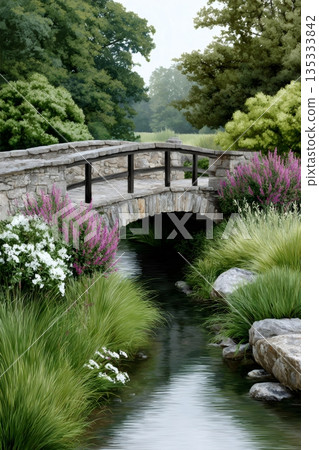 Stone bridge over flowing creek in a tranquil garden Stone bridge over flowing creek in a tranquil garden 135333842