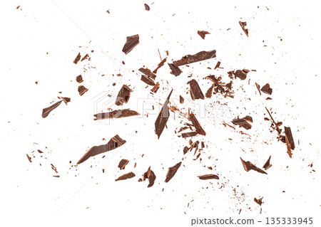 Scattered dark chocolate shards isolated on white background with dynamic flat lay and copy space 135333945