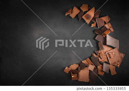 Dark Chocolate Pieces on Black Background with Copy Space Dark Chocolate Pieces on Black Background with Copy Space 135333955