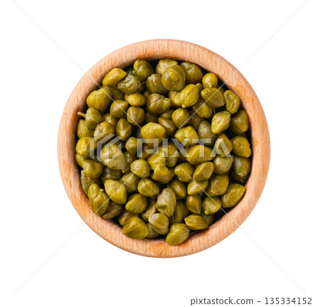 pickled capers in a wooden bowl isolated on a white background, top view. pickled capers in a wooden bowl isolated on a white background, top view. 135334152