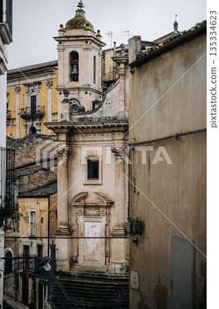 Church Of Santa Maria Dell Itria In Ragusa, Sicily: Historic Baroque Stone Facade And Bell Tower Rising Above Traditional Southern Italian Old Town Church Of Santa Maria Dell Itria In Ragusa, Sicily: Historic Baroque Stone Facade And Bell Tower Rising Above Traditional Southern Italian Old Town 135334623