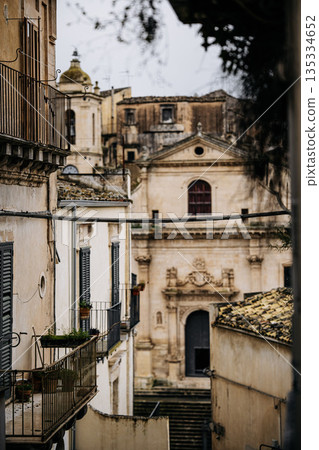 Church Of Santa Maria Dell Itria In Ragusa, Sicily: Historic Baroque Stone Facade And Bell Tower Rising Above Traditional Southern Italian Old Town 135334652
