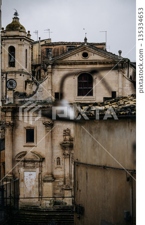 Church Of Santa Maria Dell Itria In Ragusa, Sicily: Historic Baroque Stone Facade And Bell Tower Rising Above Traditional Southern Italian Old Town Church Of Santa Maria Dell Itria In Ragusa, Sicily: Historic Baroque Stone Facade And Bell Tower Rising Above Traditional Southern Italian Old Town 135334653
