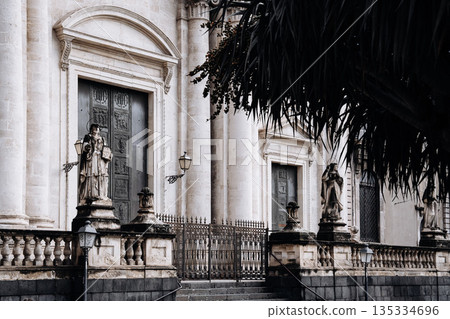 Church Of San Camillo Ai Crociferi In Catania, Sicily: Historic Baroque Church Facade With Twin Bell Towers And Stone Architecture Under Cloudy Sky 135334696