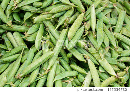 Pile of fresh green peas displayed on street food market Pile of fresh green peas displayed on street food market 135334780