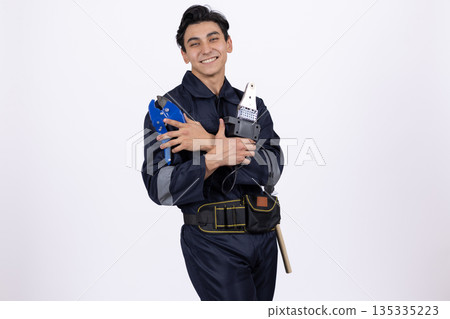 Man in blue uniform holding water bottles Man in blue uniform holding water bottles 135335223