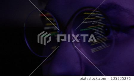 Programmer looking at code through glasses Programmer looking at code through glasses 135335275
