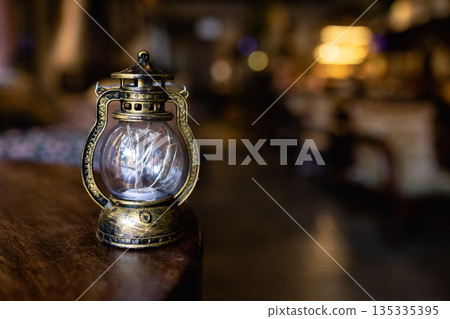 old vintage rusty kerosene black lamp isoleted on gray background. Glass oil lamp. old vintage rusty kerosene black lamp isoleted on gray background. Glass oil lamp. 135335395