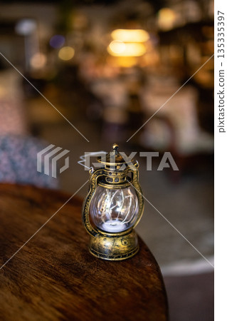 old vintage rusty kerosene black lamp isoleted on gray background. Glass oil lamp. old vintage rusty kerosene black lamp isoleted on gray background. Glass oil lamp. 135335397