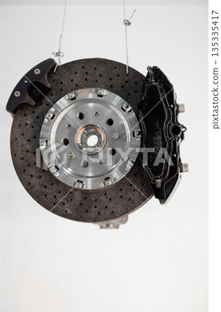 Brake discs and brake pads isolated on white background. Auto parts. Brake disc 135335417