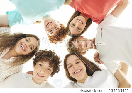 Group Portrait Of Happy Students Standing In A Circle Together 135335425