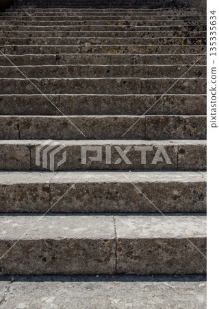An upward view of a set of weathered stone steps An upward view of a set of weathered stone steps 135335634