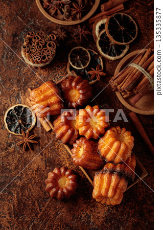 Cinnamon cakes in wooden dish on a brown background. 135335877