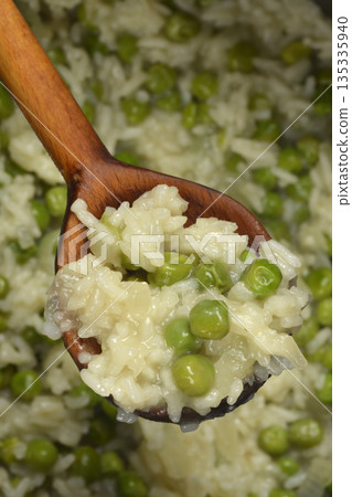 Risotto with green peas 135335940
